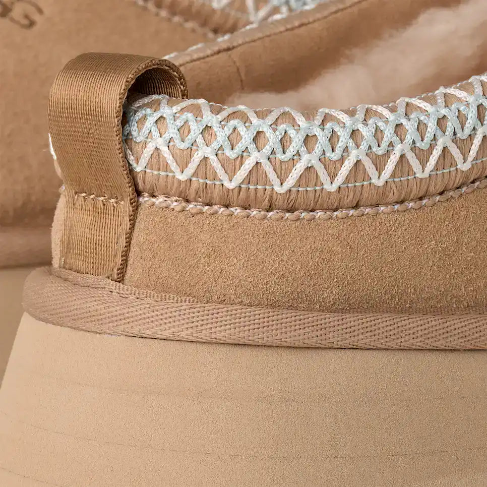 Comfortable beige slip-on sandal with detailed stitching and soft fabric lining. Perfect for casual.